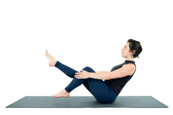 Woman practicing Yoga Core Strength Navasana Boat Pose Woman practicing Yoga Core Strength Navasana Boat Pose