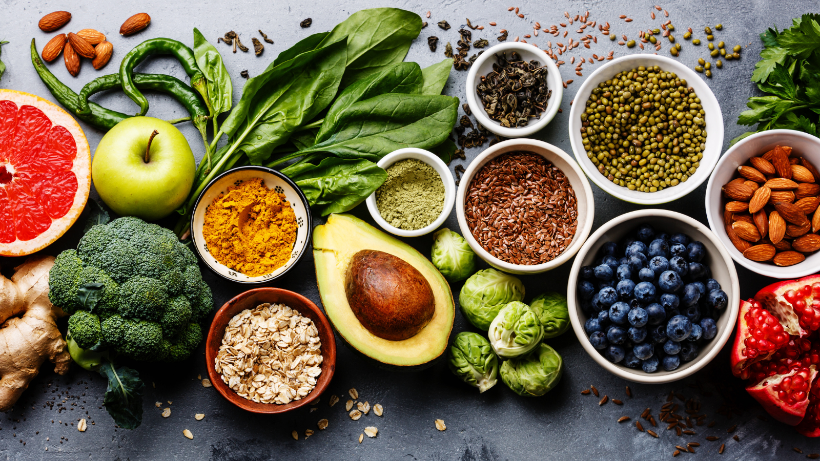 Healthy food clean eating selection: fruit, vegetable, seeds, superfood, cereal, leaf vegetables.