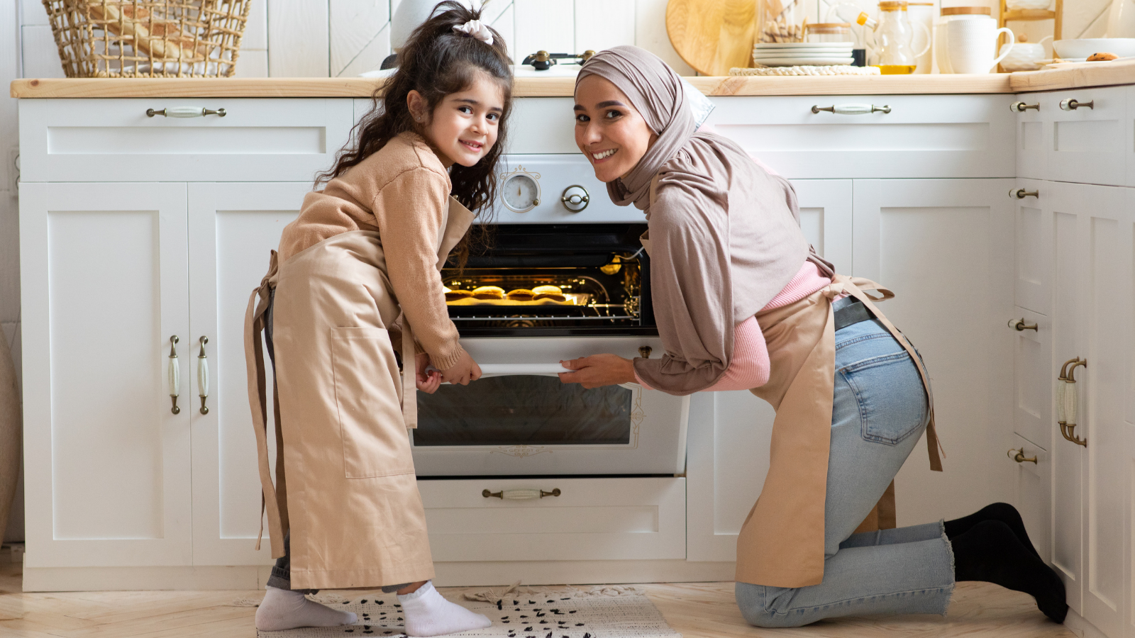 Portrait Of Happy Muslim Family Mother And Daughter Baking Together In Kitchen Interior. 