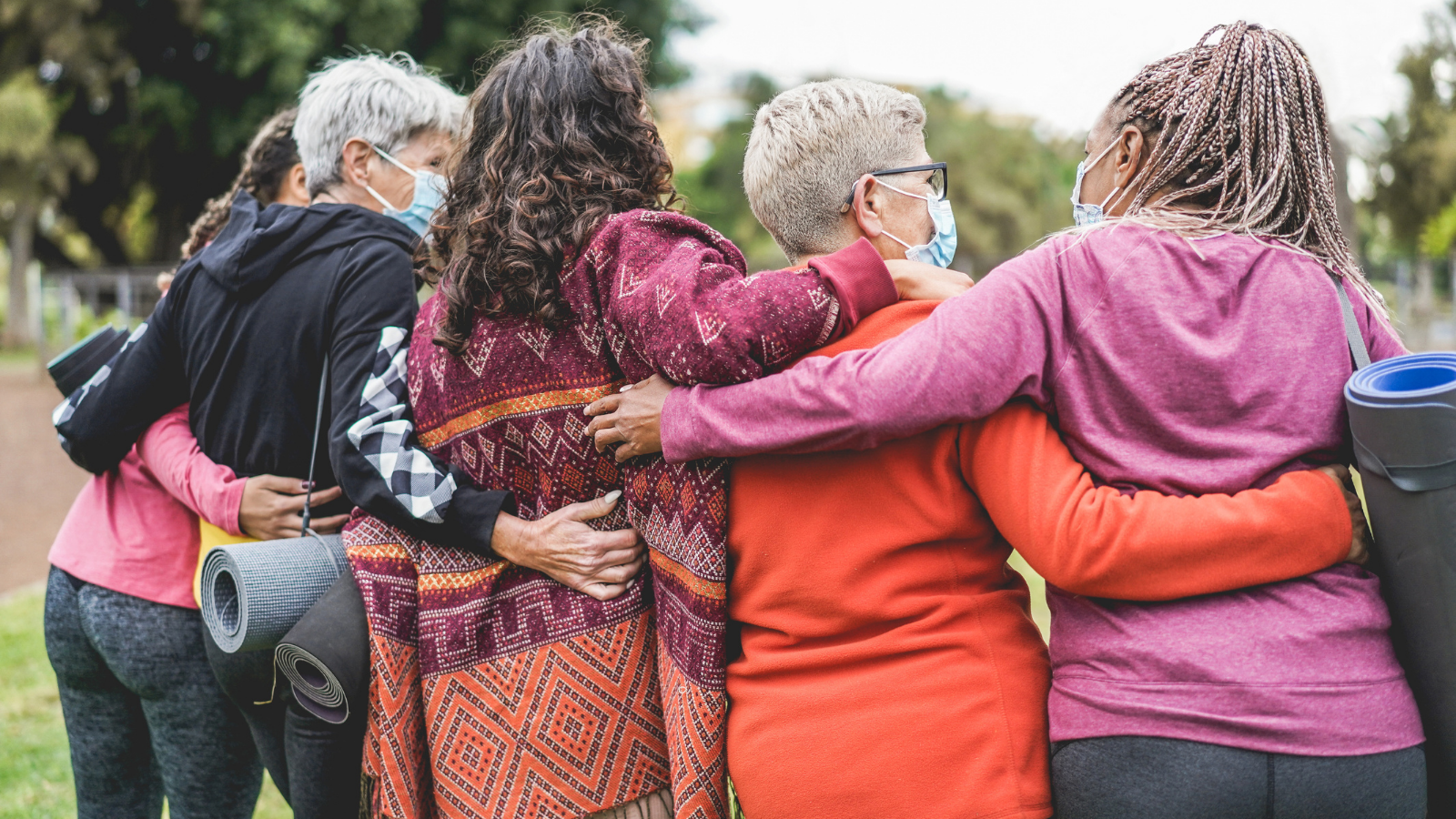 Multi generational women having fun before yoga class and experiencing the importance of friendship and human touch