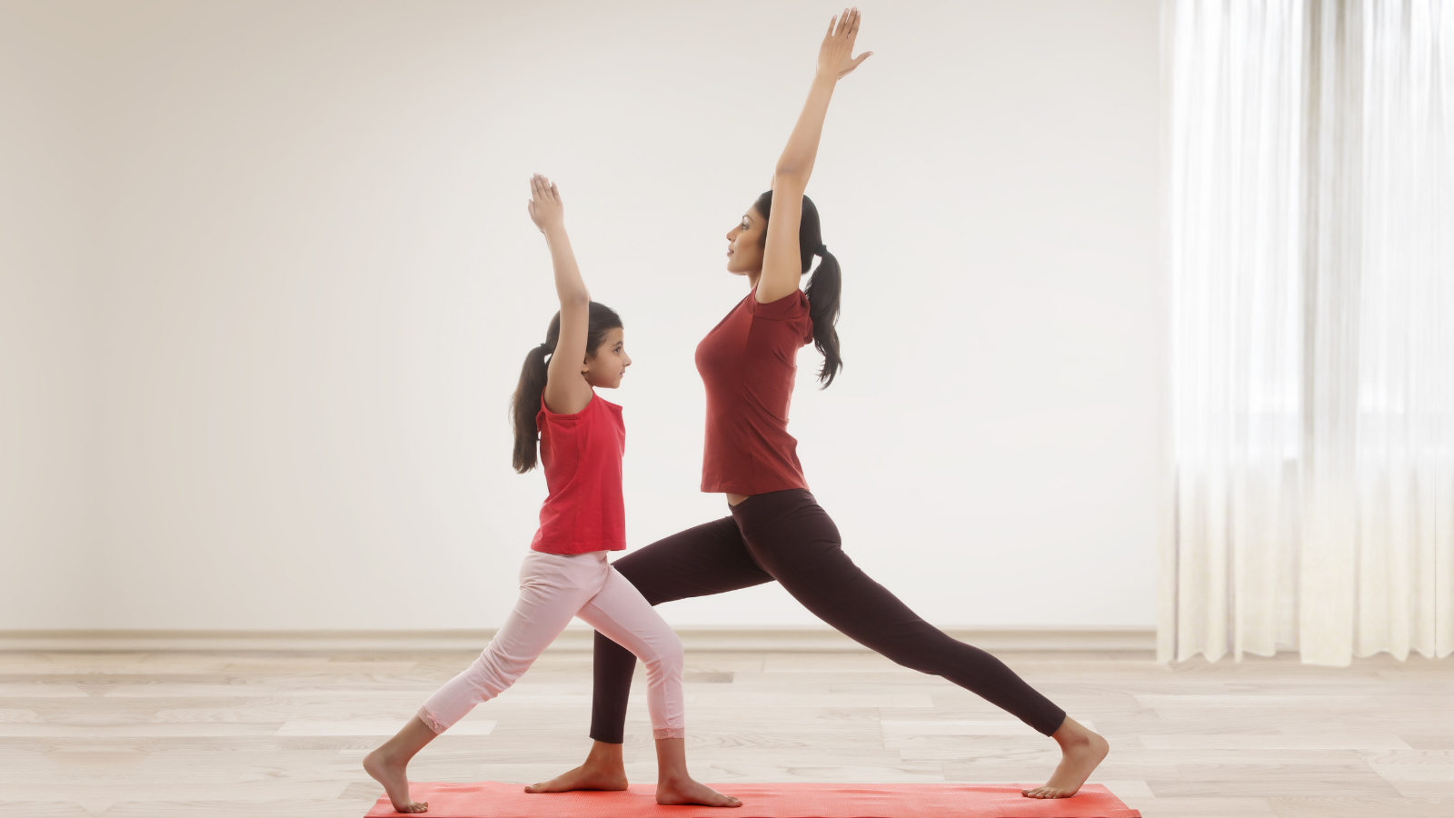 mother and daughter enjoying the benefits of yoga and exercise