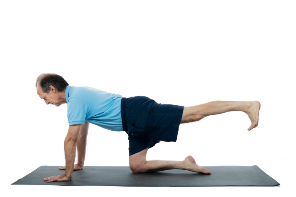 Man Practicing yoga hunting dog pose Man Practicing yoga hunting dog pose