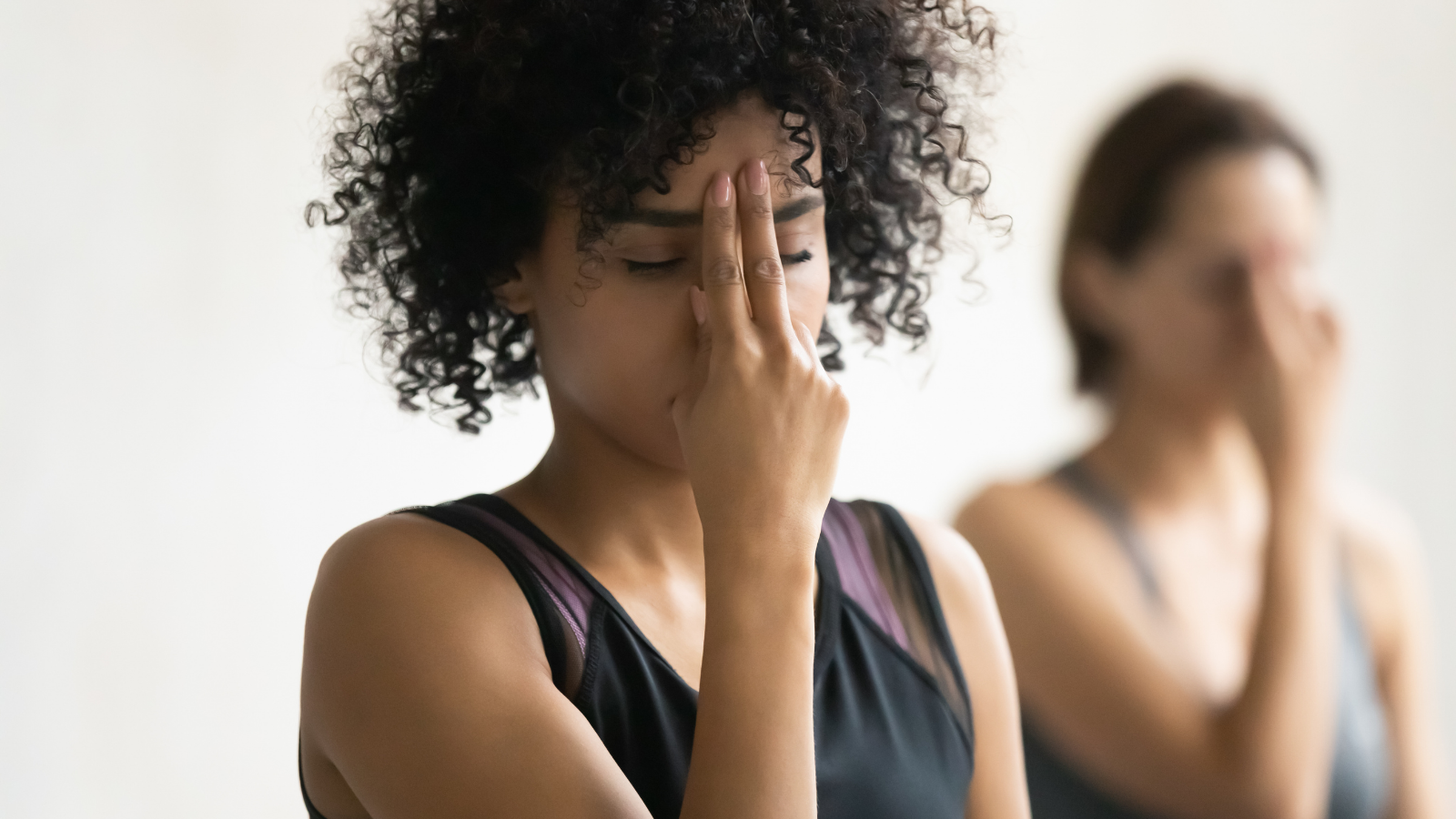 Women practicing Alternate Nostril powerful breathing practices in yoga class