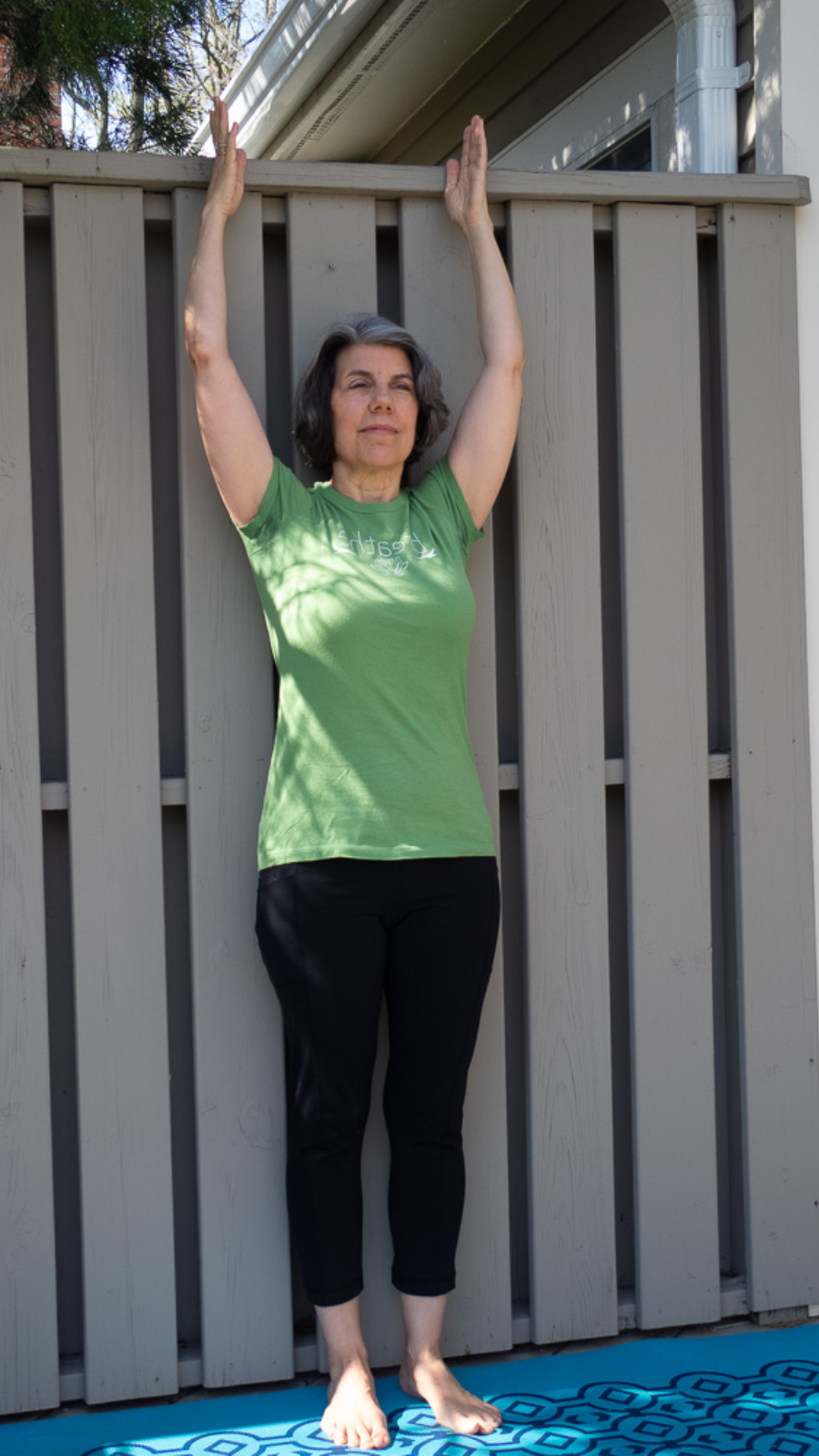 Tadasana or Mountain Pose with arms overhead variation that is good for improving posture