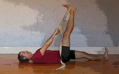 Dr. Baxter Bell practicing reclined leg stretch yoga pose (supta padangustasana)