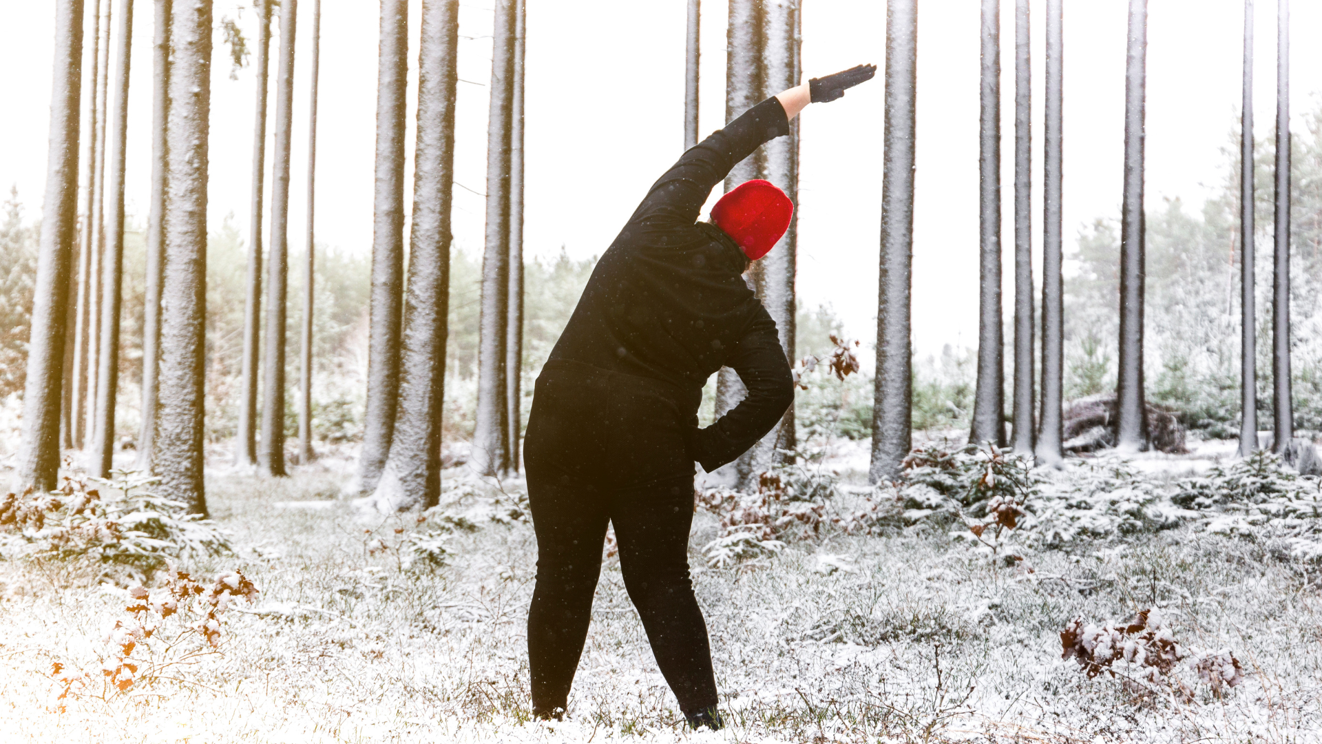Woman doing yoga in winter sun. Outdoor fitness and health concept.