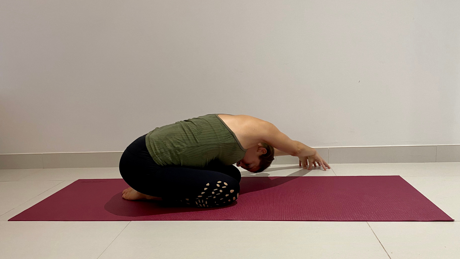 The benefits of practicing Side Reaching Child's Pose (Balasana) to stretch muscles of the back body and ease back pain