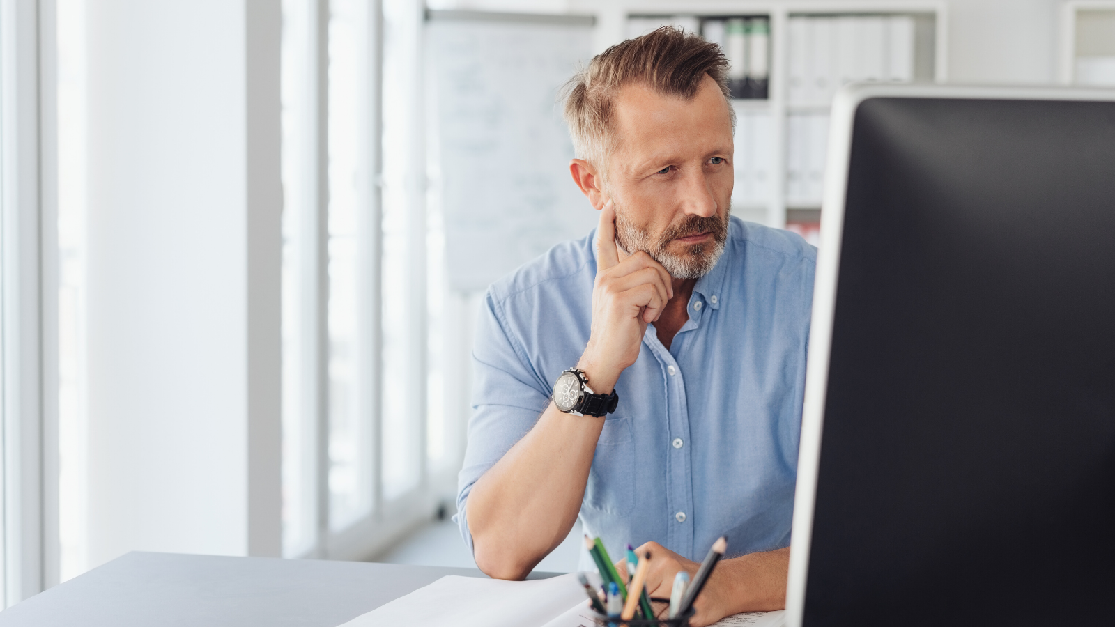 older man staring at his computer screen