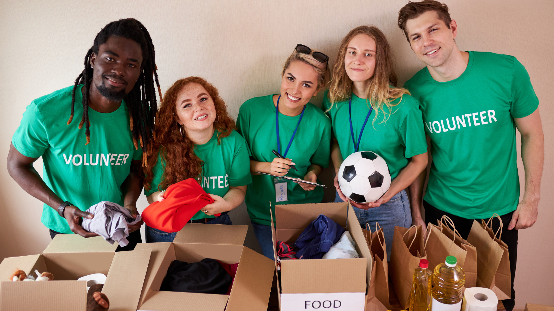 Active young diverse people enjoy volunteering at food and clothes bank.