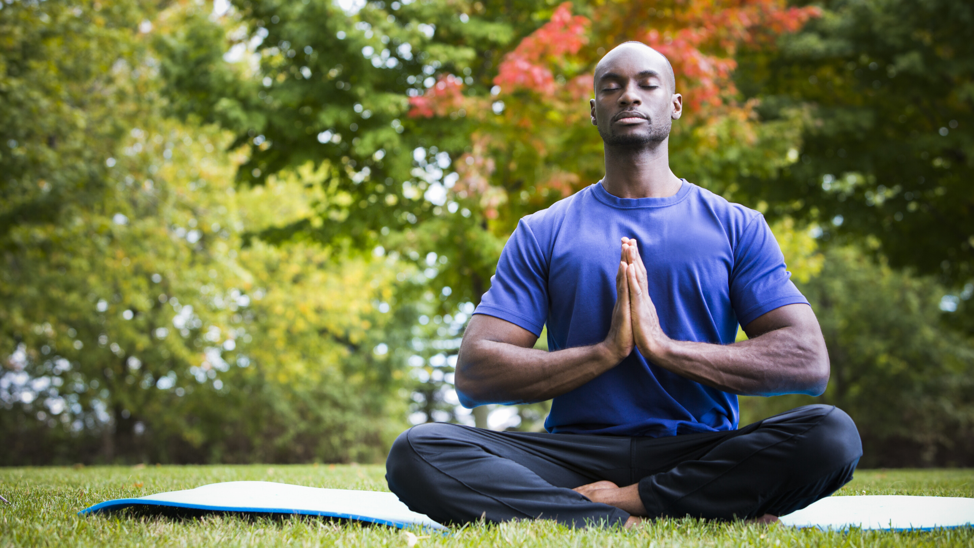 Man practicing yoga meditation with eyes closed.