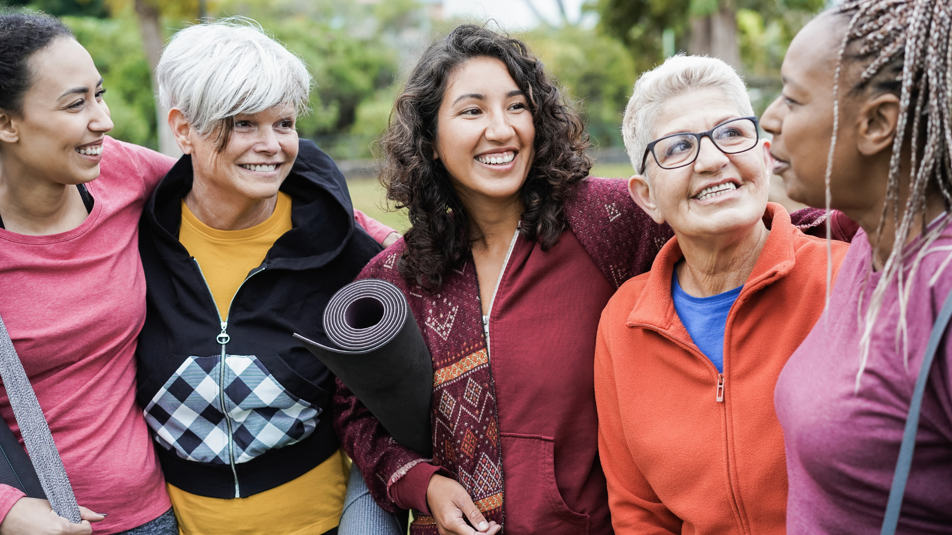 Happy multi generational women having fun together after yoga workout outdoors. 