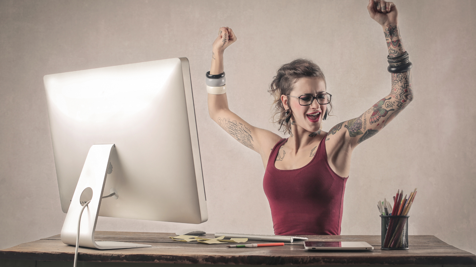 How to celebrate getting things accomplished at work Woman happy with her accomplishments at work