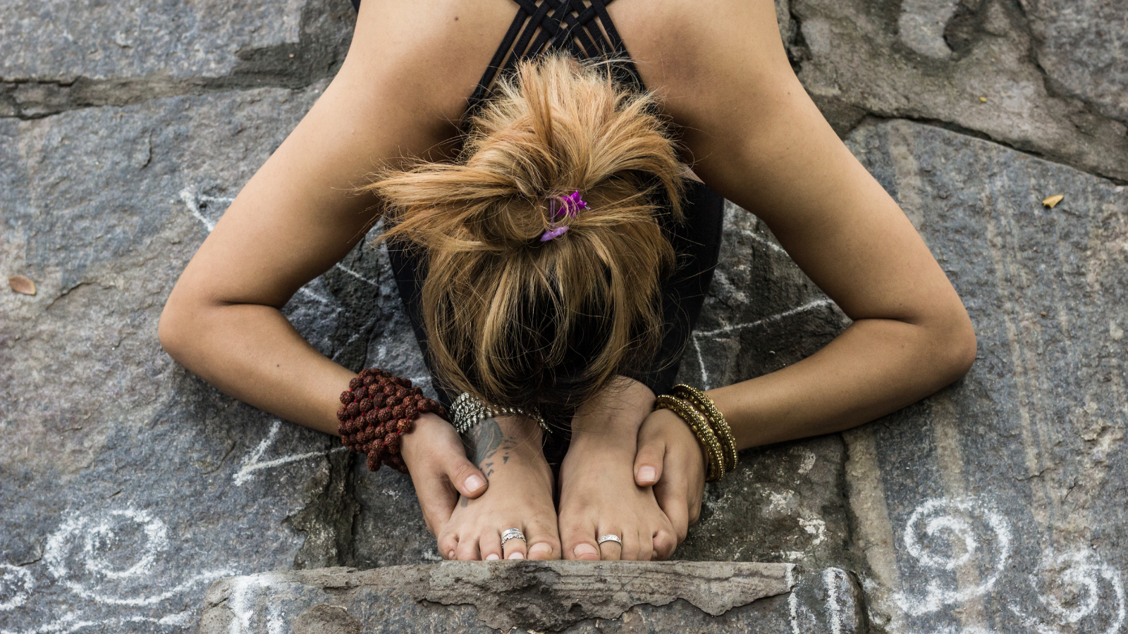 Woman practicing a deep forward fold or Paschimottanasana