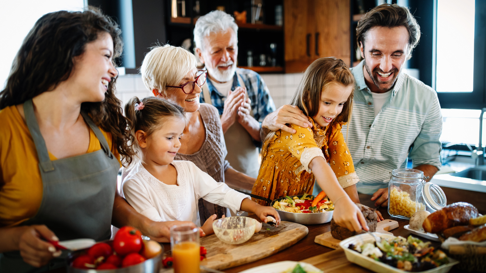 Portrait of happy family cooking in kitchen at home.