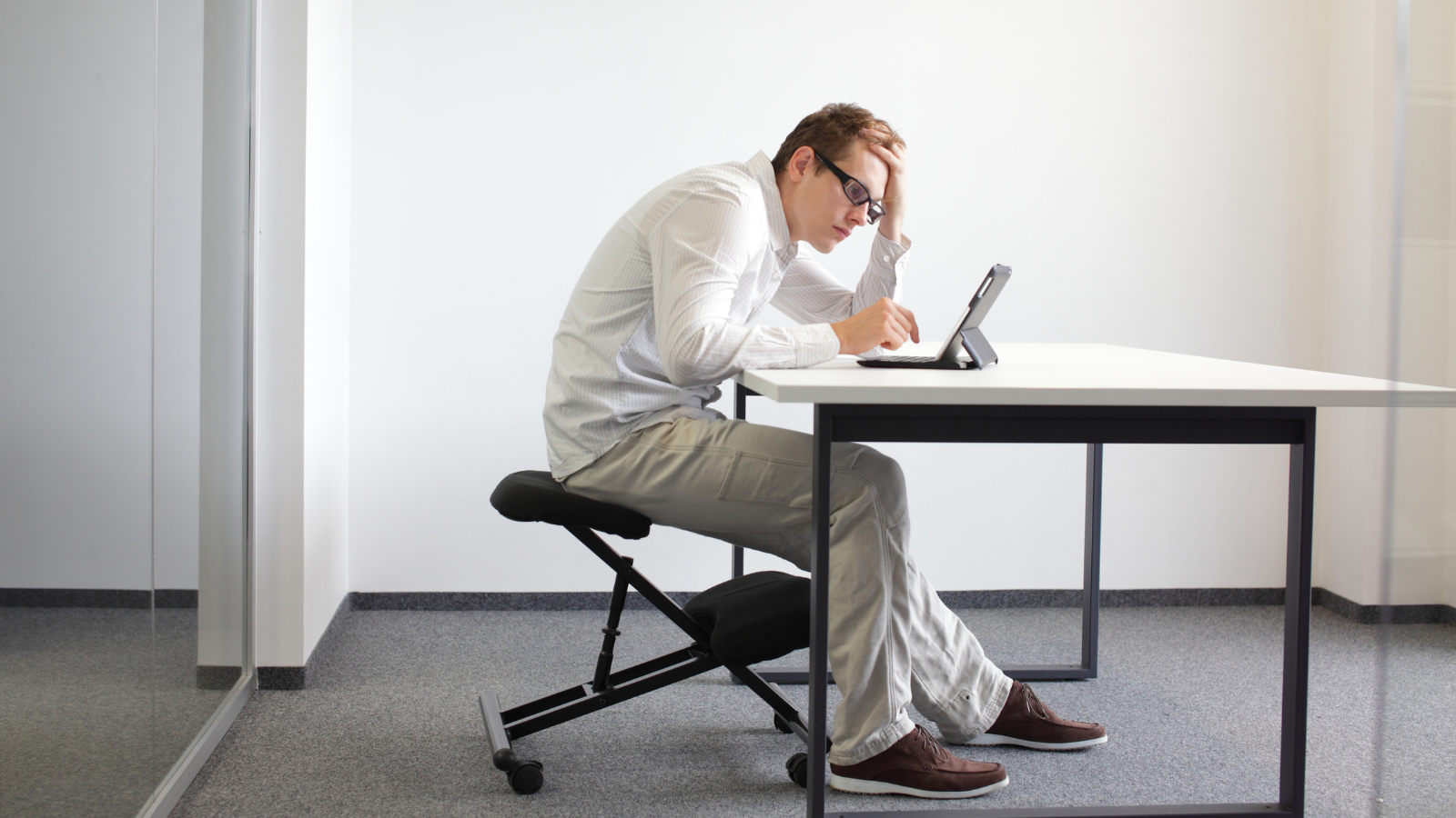 Man hunching over his computer with his head way forward.