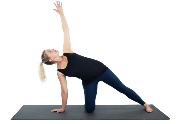 Woman practicing yoga pose - side plank variation.