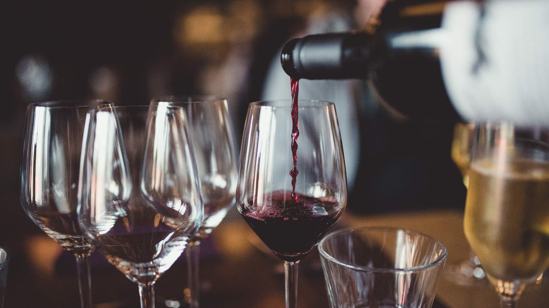 Red wine being poured into a glass.