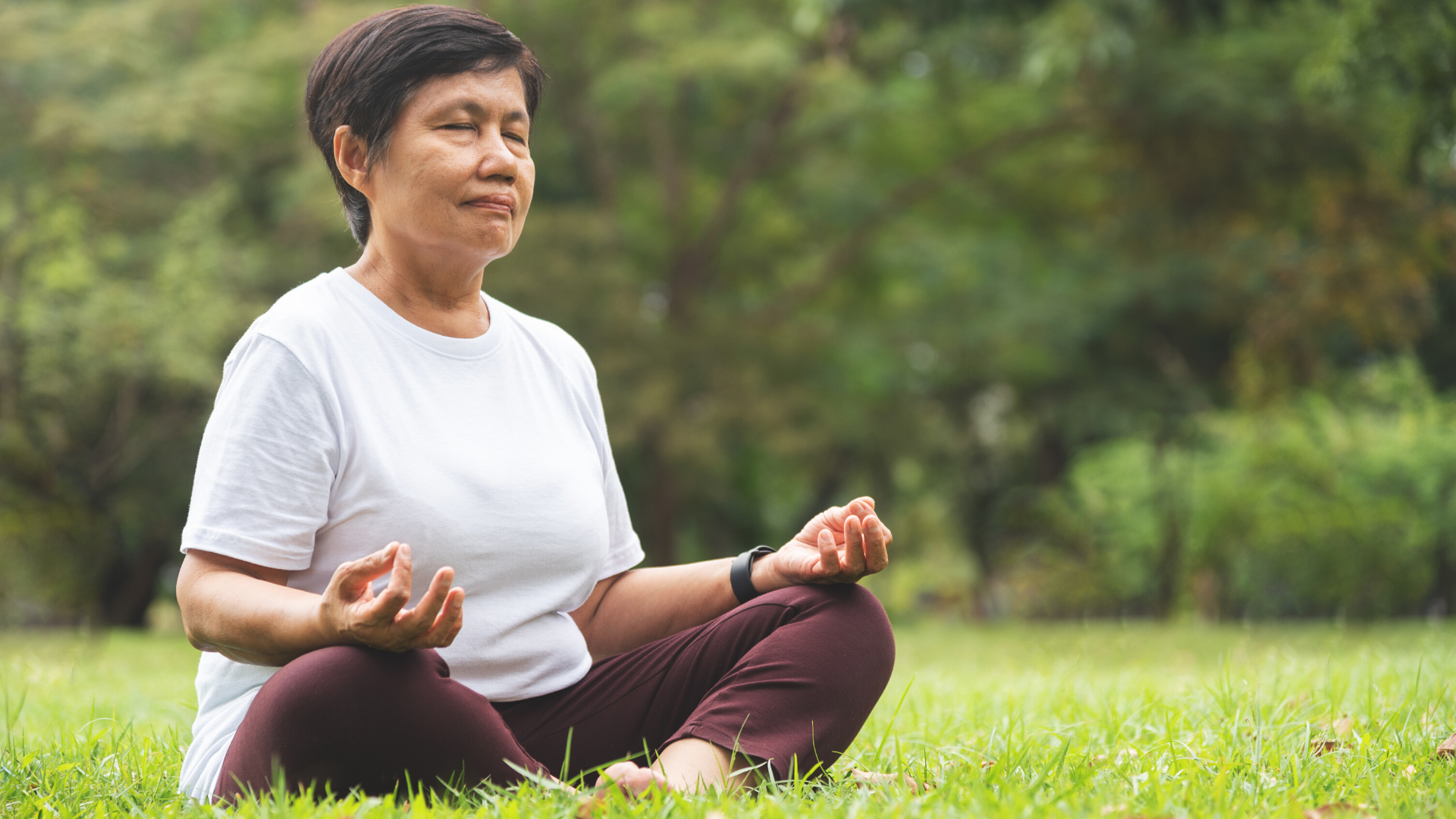 Older female yoga student practicing yoga meditation.