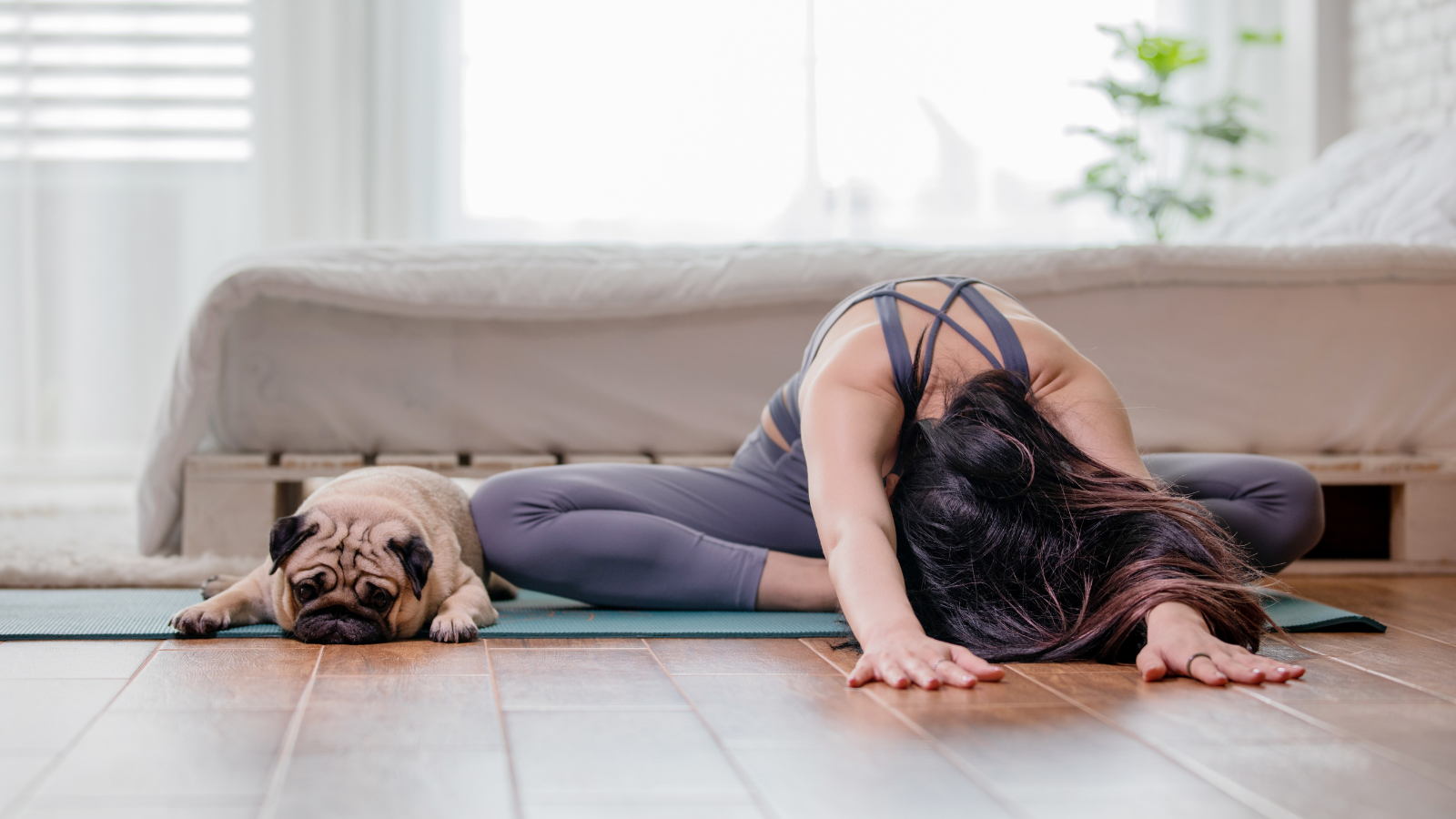 Yoga practitioner practicing at home yoga to ground in the moment and take a break from technology