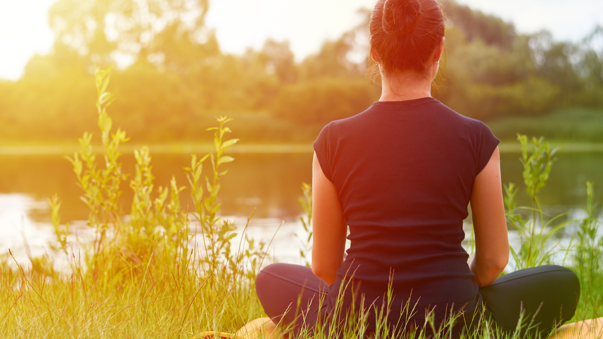 Young girl practices yoga on the shore of the River, the concept of peeling back the layers of self awareness. 