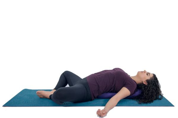 Woman practicing relaxing yoga pose - Supta Baddha Konasana Woman practicing relaxing yoga pose - Supta Baddha Konasana