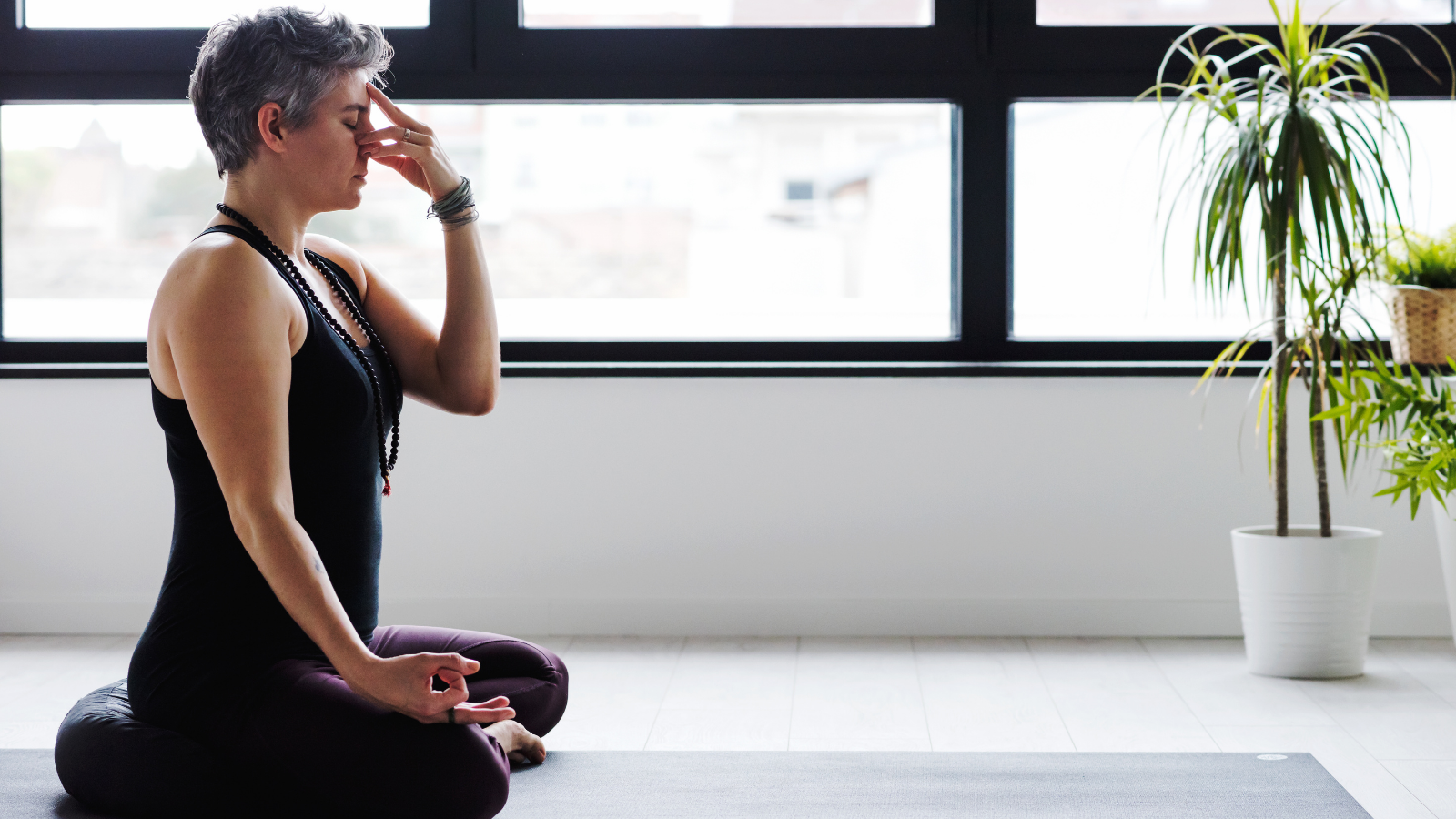 Woman practicing Pranayama as a practice to promote wellbeing and healthy relationships