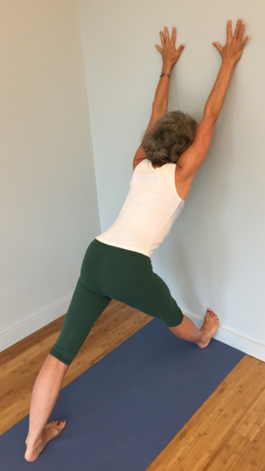 Practicing Pyramid Pose or Parsvottanasana at the wall