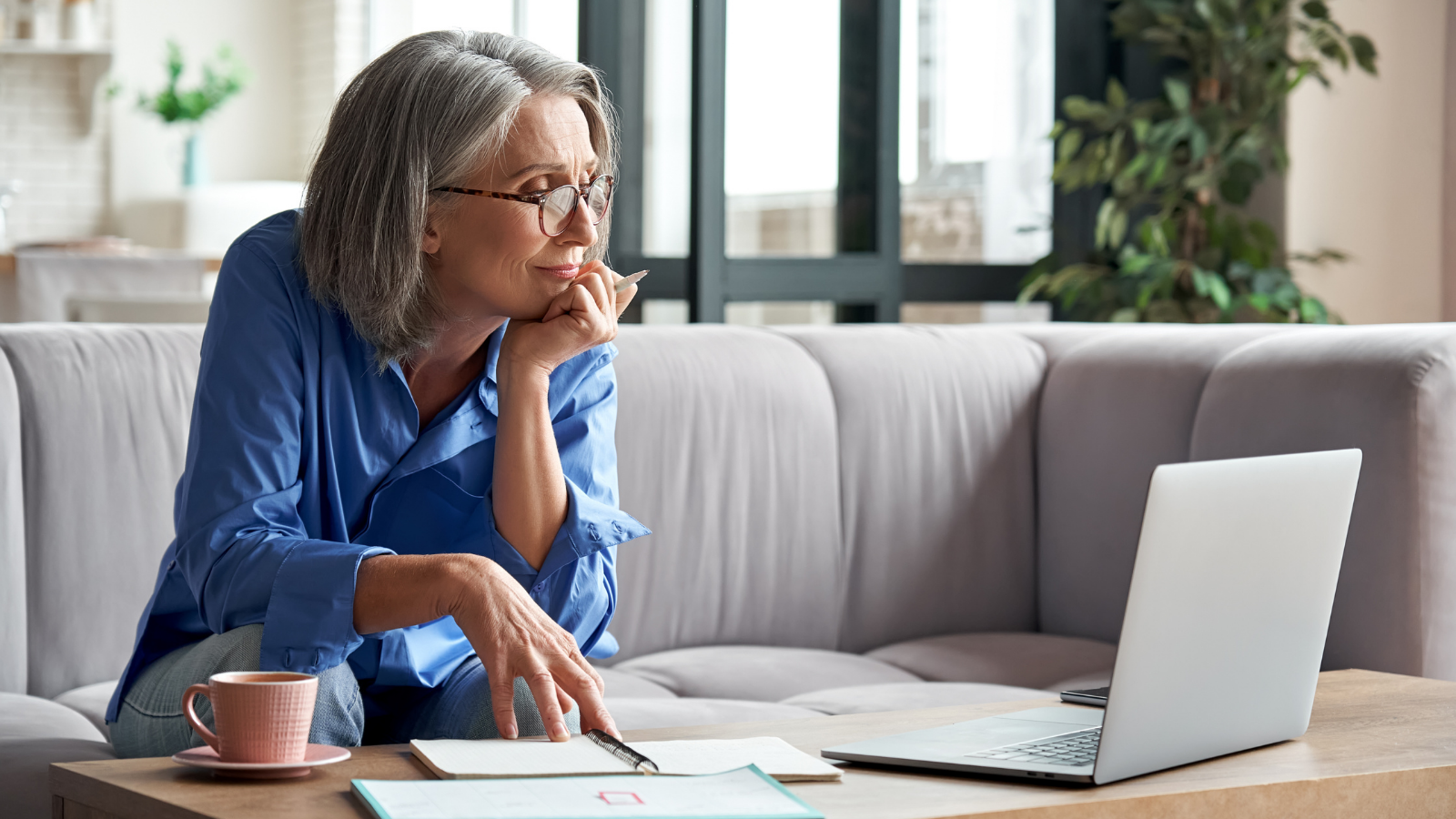Senior mature older woman watching business training, online webinar on laptop computer remote working.
