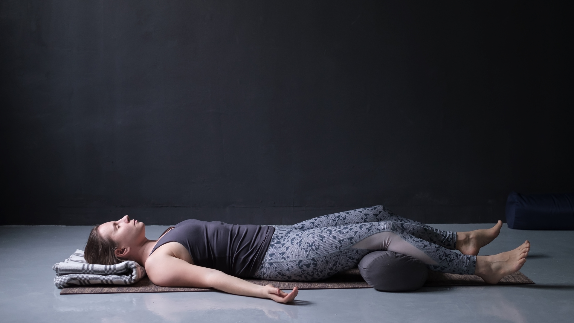 young woman  practicing Savasana or Corpse Pose or resting after practice.