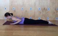 woman practicing Cobra  yoga pose (bhujangasana) to relieve neck pain