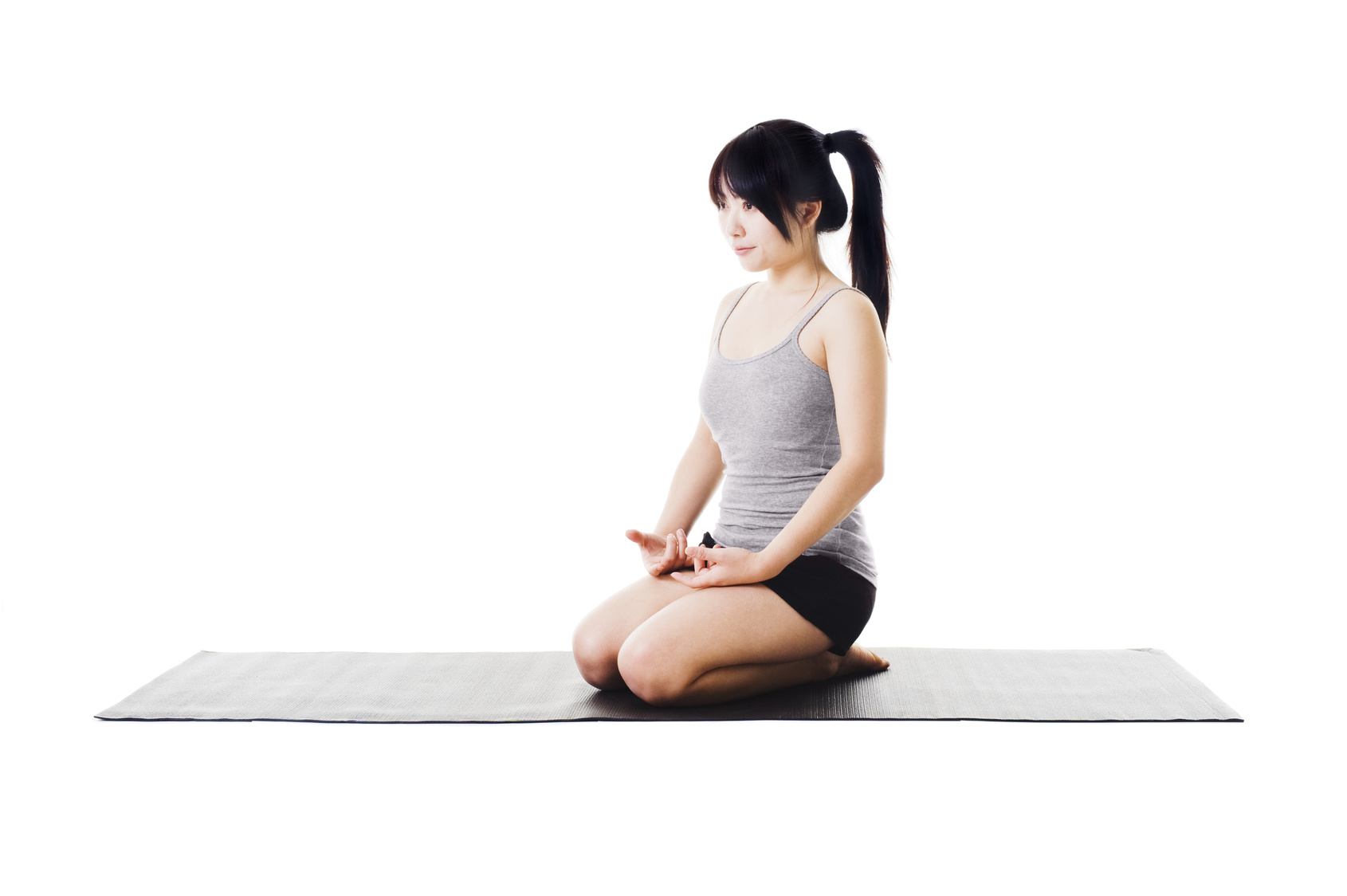 Virasana Pose A woman in Hero's Pose (Virasana Pose) for stability