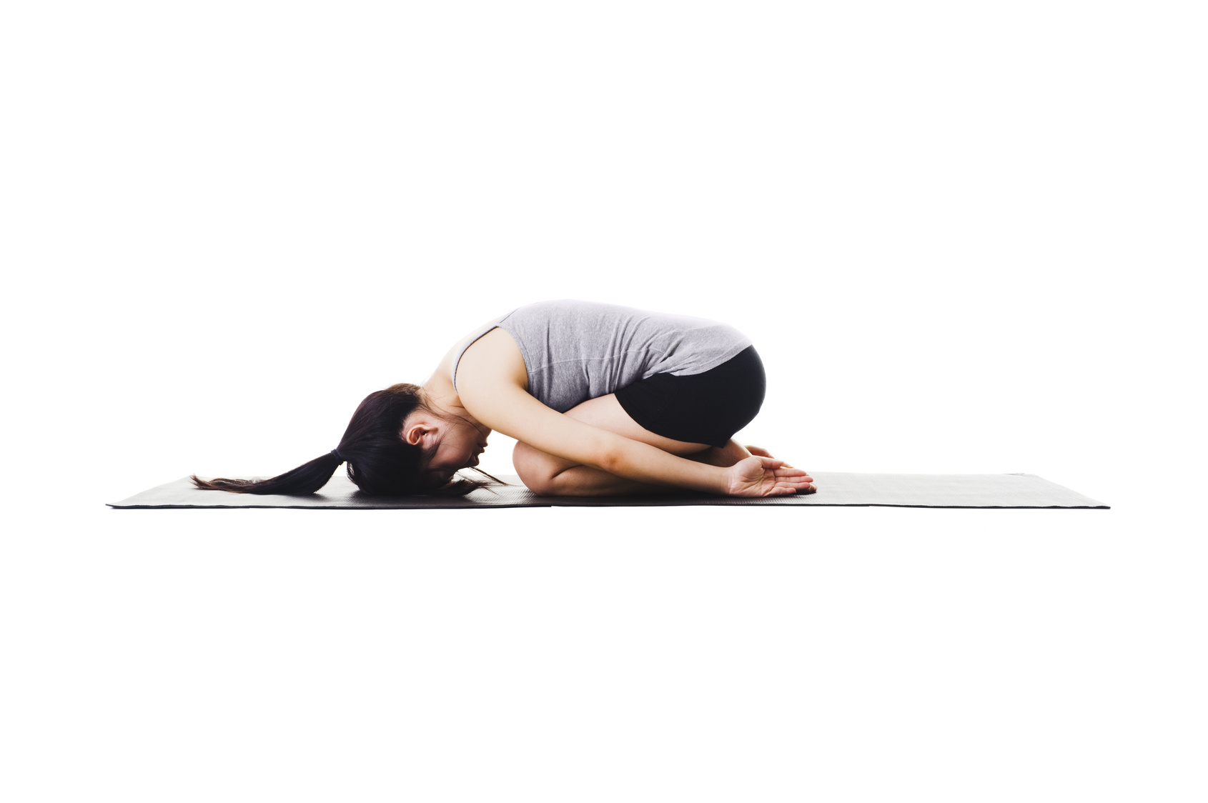 Embryo Pose A woman in a variation of Child's Pose called Embryo Pose in order to rest and ground the body