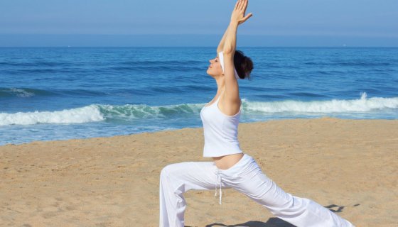 A woman in Warrior 1 pose (Virabhadrasana I), practicing yoga for inner strength