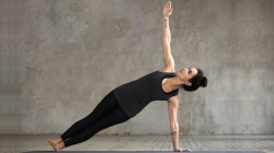 Young woman practicing yoga's, Vasisthasana Pose also known as Side Plank pose.