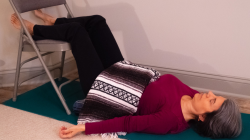 A variation of Viparita Karani or Legs Up the Wall Pose practiced with a chair