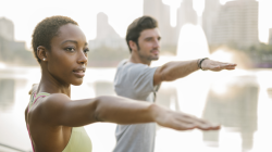 Yoga students practicing Warrior II Pose (Virabhadrasana I) to care for and listen to the body