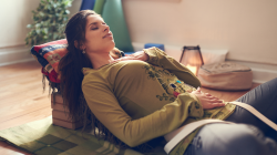 Serene lady relaxing and meditating as preparation for a great night's sleep