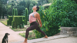 Flexible positive young yogi practicing a Warrior Pose variation.