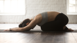 Young attractive sporty yogi practicing yogas Child's Pose or Balasana Pose