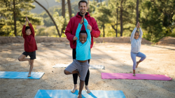Yoga class of kids practicing Tree Pose (Vrksasana)