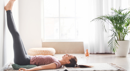 Beautiful young woman practicing yoga at home. Concept of finding contentment in the simple things i
