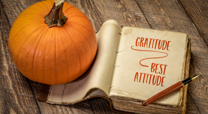 gratitude - best attitude, inspirational handwriting in a retro, leatherbound journal with a pumpkin