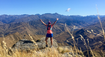  Image depicts Runner on top of a mountain.