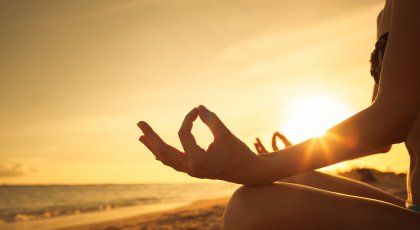 yoga student practicing yogic mudra position with hands