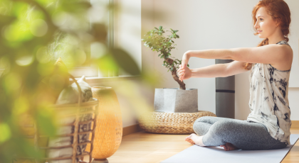 Woman stretching her hands, and taking care of her wrists-warming-up for yoga class