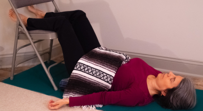 A variation of Viparita Karani or Legs Up the Wall Pose practiced with a chair