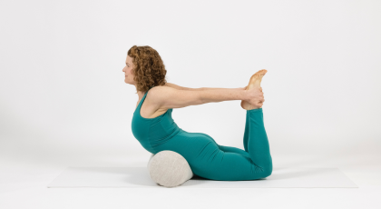 Supported Bow Pose. A restorative version of Bow Pose or Dhanuransana a backbend