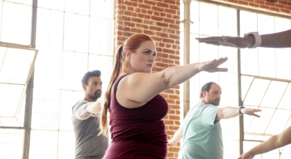 Yoga students in class practicing Warrior II (Virabhadrasana II) to reduce anxiety and stress