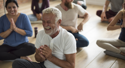 Image depicts yoga, mindfulness and community. Diversity and people together in yoga class.