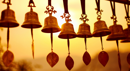 Nepali traditional Bells over the sun at sunset